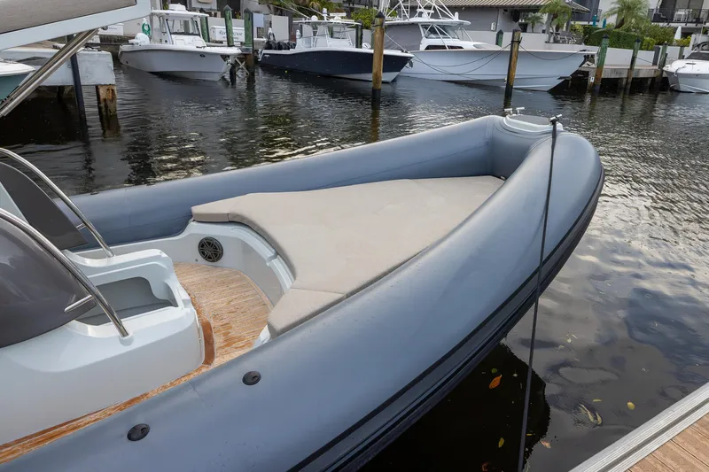  Yacht Photos Pics 2024 SACS Strider 900 boat docked, featuring sleek design and spacious seating area.