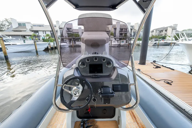  Yacht Photos Pics 2024 SACS Strider 900 boat cockpit with modern steering and dashboard controls.