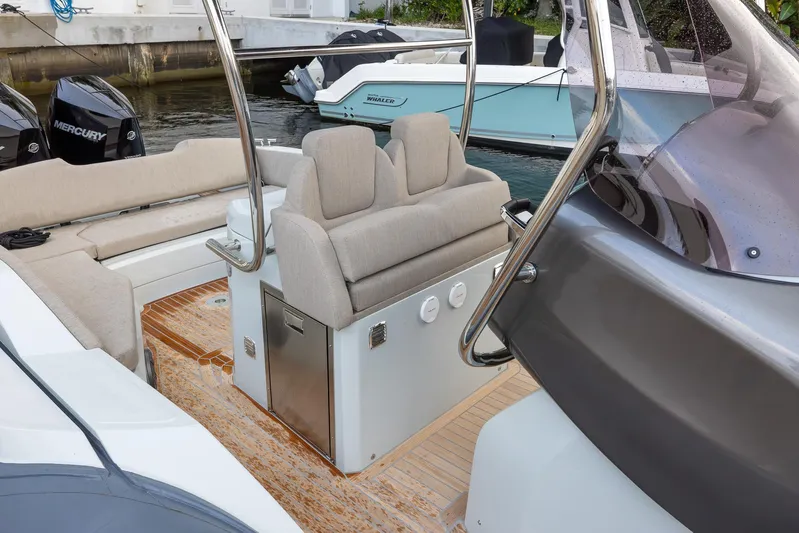  Yacht Photos Pics 2024 SACS Strider 900 boat interior with cushioned seating and sleek design.