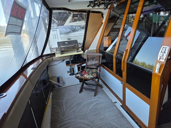 Steel Leader Yacht Photos Pics 1990 Bayliner 4588 Motoryacht interior with wooden accents and seating area.