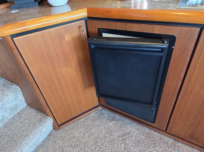 Steel Leader Yacht Photos Pics Wooden cabinetry and mini fridge in 1990 Bayliner 4588 Motoryacht interior.