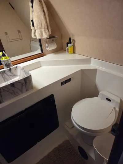 Steel Leader Yacht Photos Pics Bathroom interior of 1990 Bayliner 4588 Motoryacht with modern fixtures and marble sink.