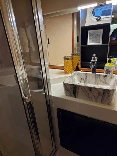 Steel Leader Yacht Photos Pics Luxurious bathroom in 1990 Bayliner 4588 Motoryacht with marble sink and modern fixtures.