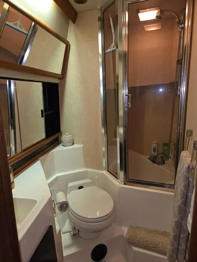 Steel Leader Yacht Photos Pics Bathroom of 1990 Bayliner 4588 Motoryacht with shower, toilet, and mirror.