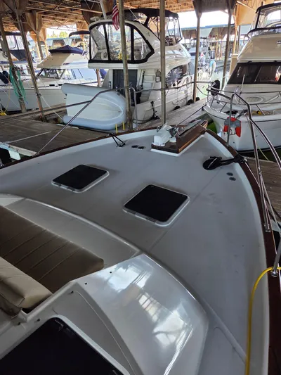 Steel Leader Yacht Photos Pics 1990 Bayliner 4588 Motoryacht docked in a marina, showcasing its spacious deck and sleek design.