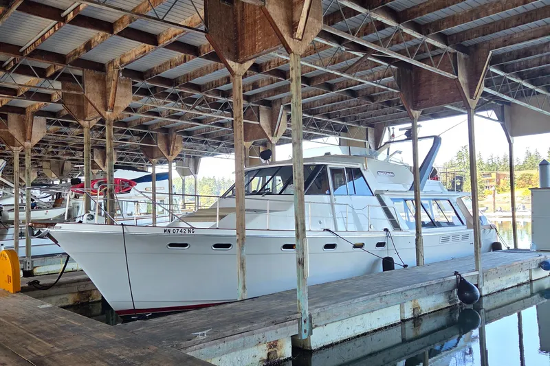 Steel Leader Yacht Photos Pics 1990 Bayliner 4588 Motoryacht docked in a covered marina slip.