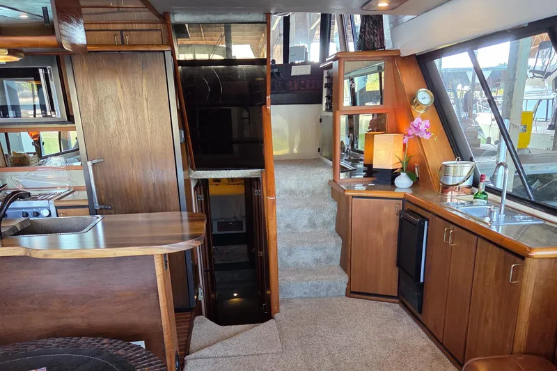 Steel Leader Yacht Photos Pics Luxurious interior of a 1990 Bayliner 4588 Motoryacht with wood finishes and modern amenities.