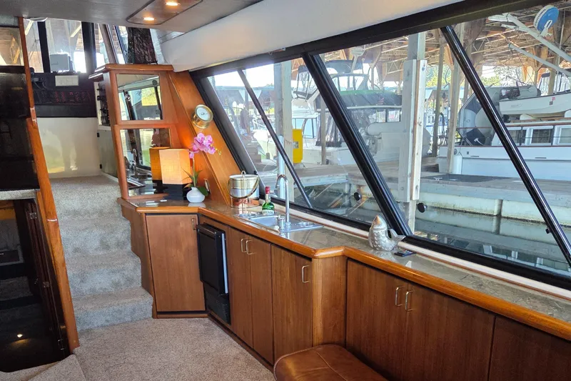 Steel Leader Yacht Photos Pics Luxurious interior of 1990 Bayliner 4588 Motoryacht with large windows and elegant wood finishes.