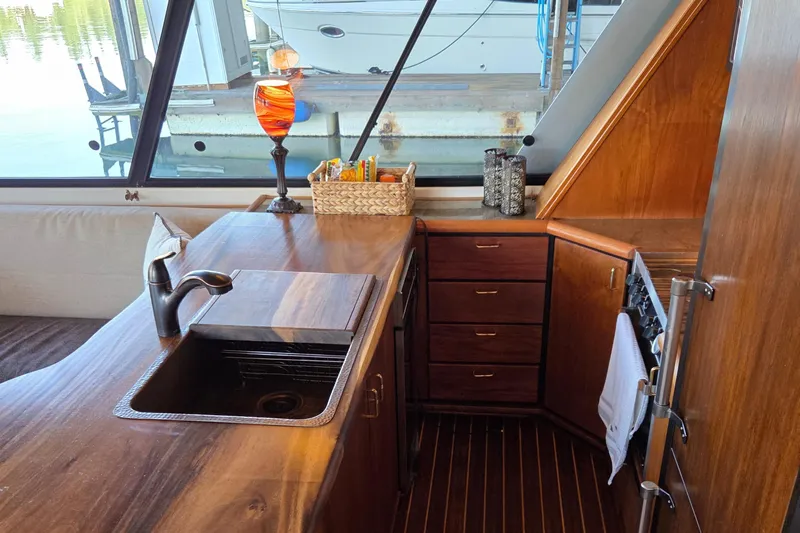 Steel Leader Yacht Photos Pics Luxurious 1990 Bayliner 4588 Motoryacht kitchen with wood cabinetry and modern fixtures.