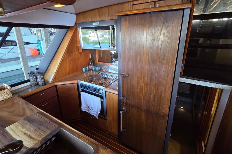 Steel Leader Yacht Photos Pics 1990 Bayliner 4588 Motoryacht kitchen with wood cabinetry and modern appliances.
