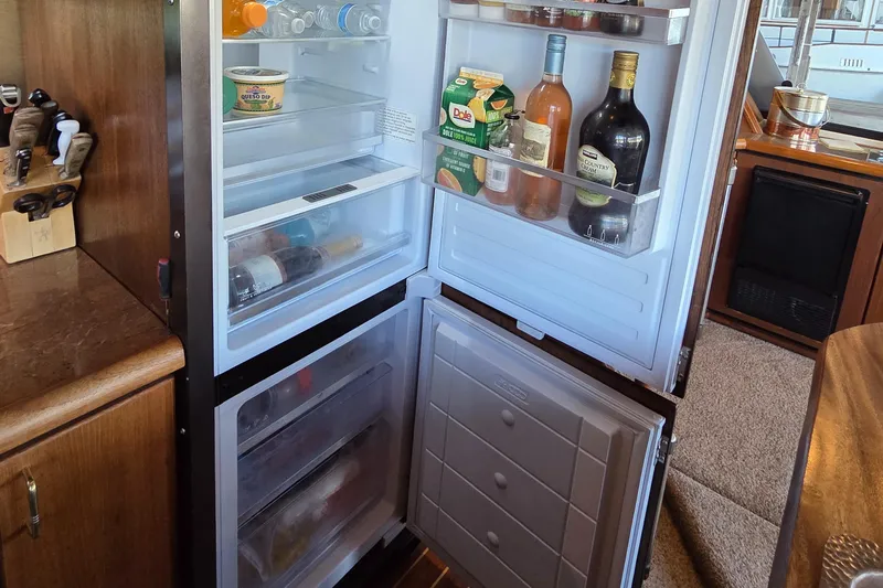 Steel Leader Yacht Photos Pics Refrigerator stocked with beverages and food inside a 1990 Bayliner 4588 Motoryacht kitchen.