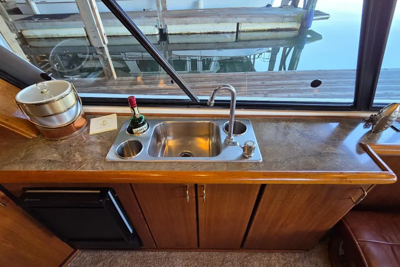 Steel Leader Yacht Photos Pics 1990 Bayliner 4588 Motoryacht kitchen with sink, countertop, and window view.