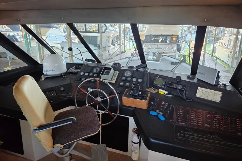Steel Leader Yacht Photos Pics Interior helm of 1990 Bayliner 4588 Motoryacht with steering wheel and navigation equipment.