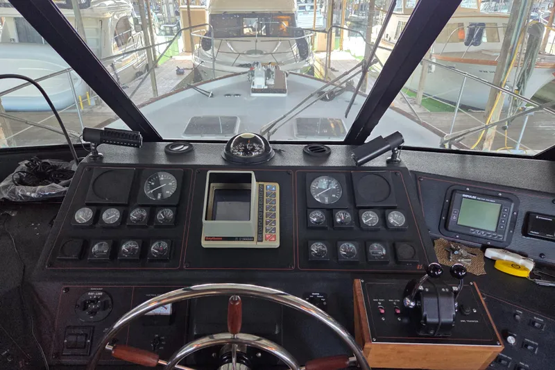 Steel Leader Yacht Photos Pics Cockpit of a 1990 Bayliner 4588 Motoryacht with navigation instruments and steering wheel.