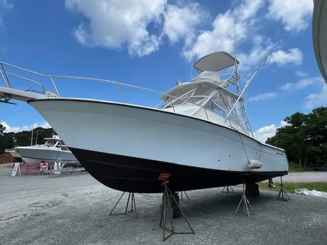 The Big O Yacht Photos Pics 2002 Grady-White 330 Express boat on stands under a blue sky.