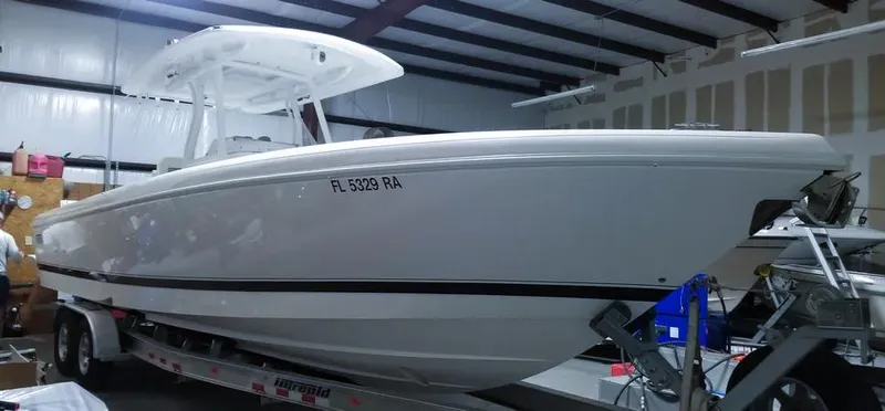  Yacht Photos Pics 2016 Intrepid 327 Center Console boat on trailer in storage facility.