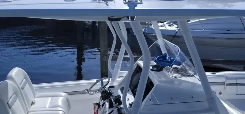  Yacht Photos Pics 2016 Intrepid 327 Center Console boat with seating and helm, docked by the water.