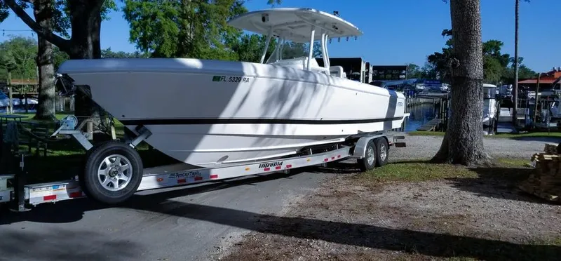  Yacht Photos Pics 2016 Intrepid 327 Center Console boat on trailer, parked near a marina.