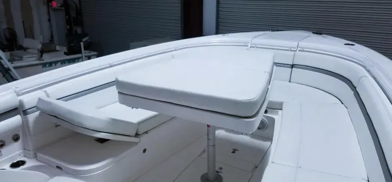  Yacht Photos Pics 2016 Intrepid 327 Center Console boat interior with white seating and table.