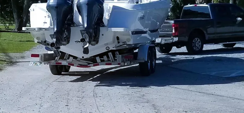  Yacht Photos Pics 2016 Intrepid 327 Center Console boat on trailer, hitched to a pickup truck.