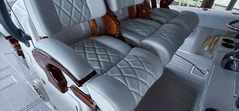  Yacht Photos Pics Luxurious seating on a 2019 Freeman 42 LR boat with quilted leather and wooden accents.
