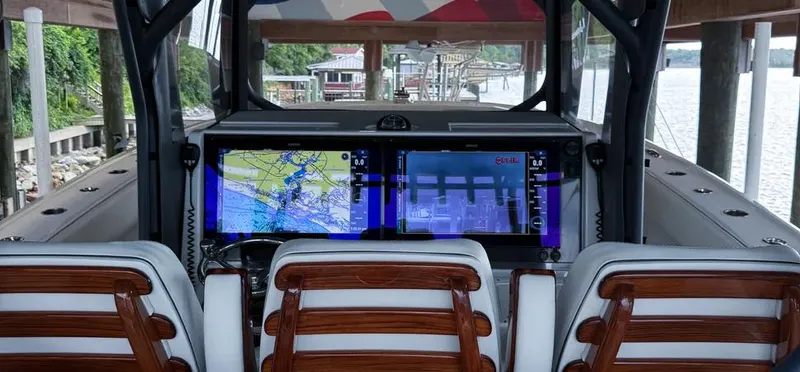  Yacht Photos Pics Helm of 2019 Freeman 42 LR boat with advanced navigation screens and wooden seats.