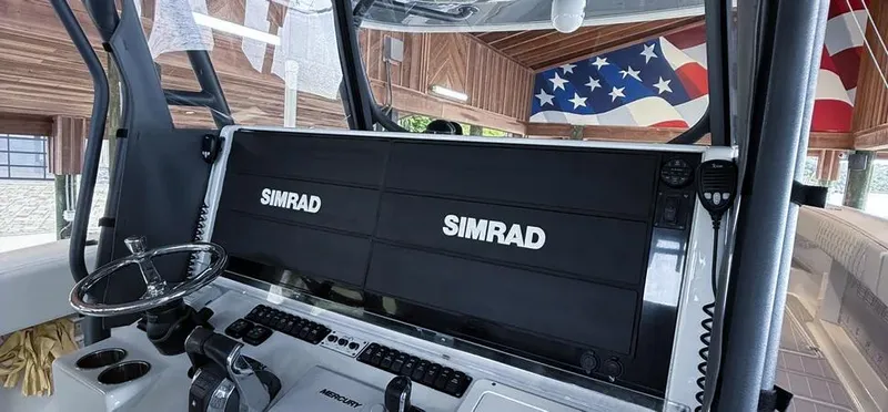  Yacht Photos Pics Control panel of a 2019 Freeman 42 LR boat with Simrad displays and American flag decor.