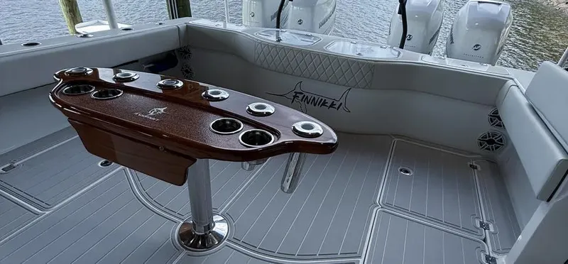  Yacht Photos Pics 2019 Freeman 42 LR boat deck with fishing rod holders and seating, overlooking water.