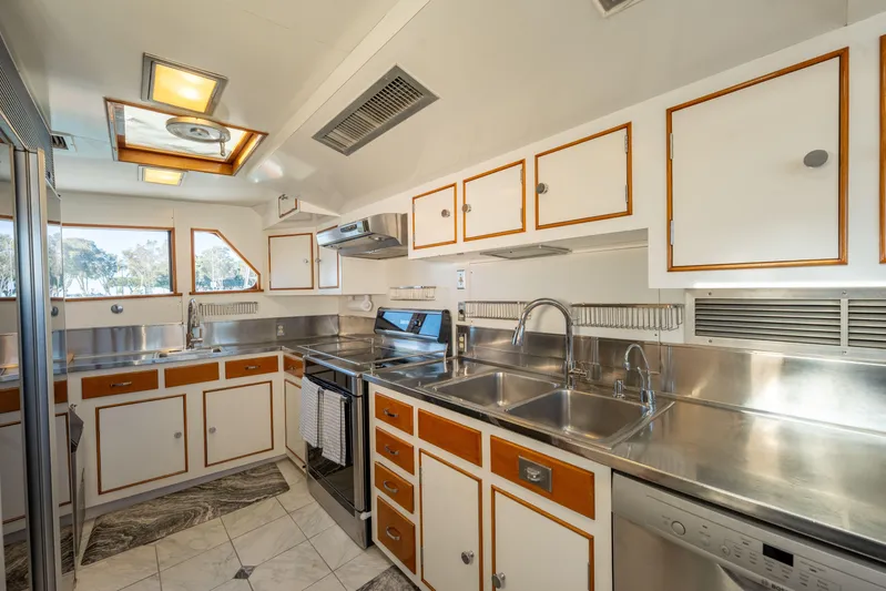 Nordic Star Yacht Photos Pics 1969 Lantana Custom yacht kitchen with stainless steel counters and white cabinetry.