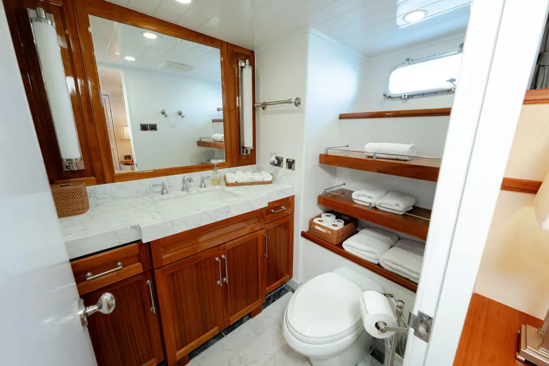 Nordic Star Yacht Photos Pics Luxurious yacht bathroom with wooden cabinets, marble countertop, and neatly arranged towels. Lantana Custom 1969.