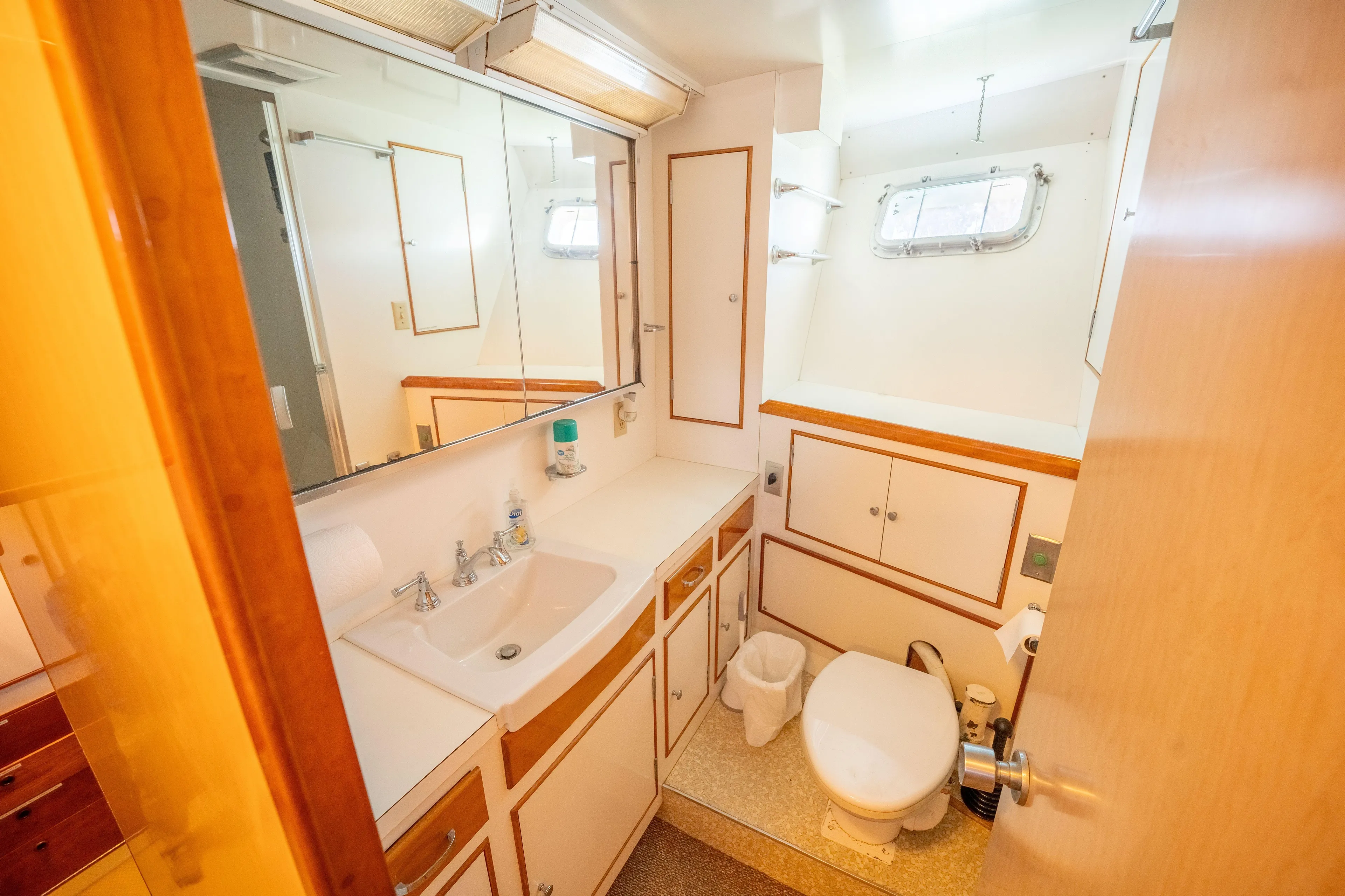 Nordic Star Yacht Photos Pics Vintage 1969 Lantana Custom yacht bathroom with sink, toilet, and storage cabinets.