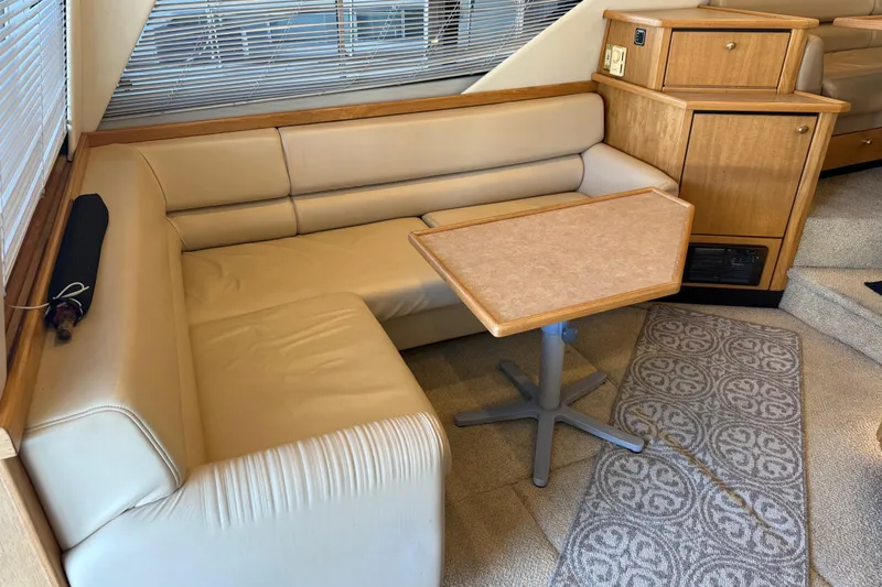 Touchdown Yacht Photos Pics Interior of 2000 Bayliner 3988 Command Bridge Motoryacht with beige seating and wooden accents.