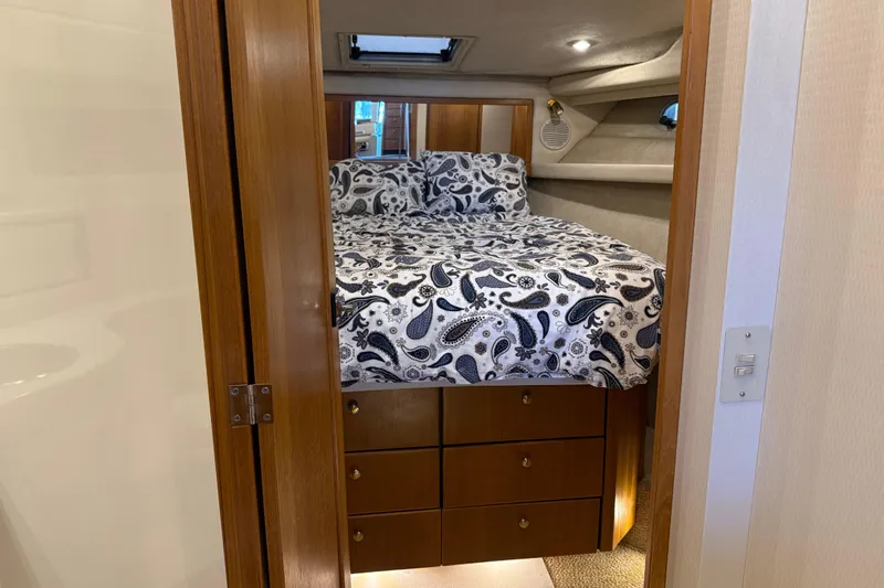 Touchdown Yacht Photos Pics Cozy bedroom in 2000 Bayliner 3988 Command Bridge Motoryacht with paisley bedding.