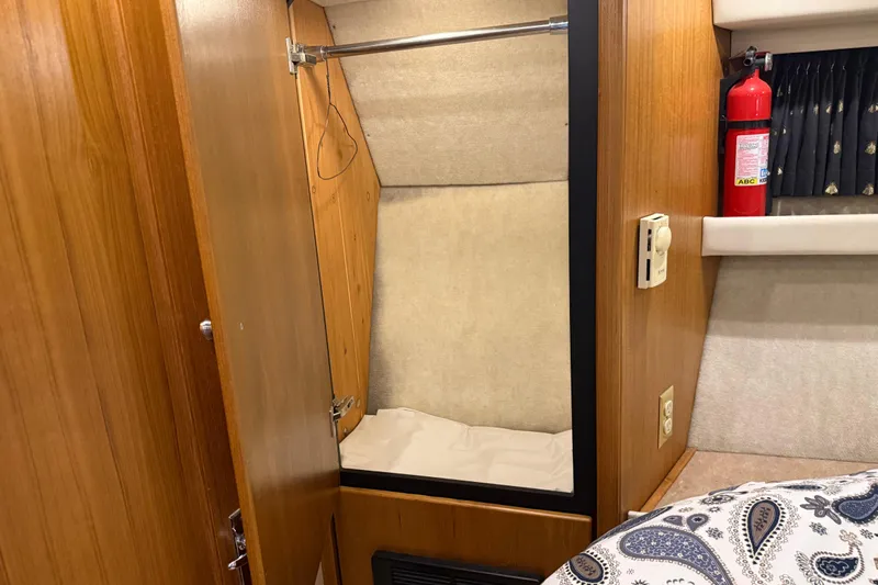 Touchdown Yacht Photos Pics 2000 Bayliner 3988 Command Bridge Motoryacht interior with closet and fire extinguisher.