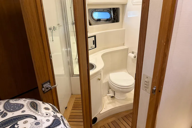 Touchdown Yacht Photos Pics Bathroom interior of 2000 Bayliner 3988 Command Bridge Motoryacht with wooden accents.