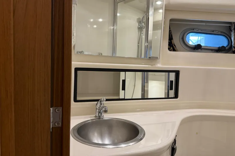 Touchdown Yacht Photos Pics Bathroom interior of 2000 Bayliner 3988 Command Bridge Motoryacht with sink and mirror.