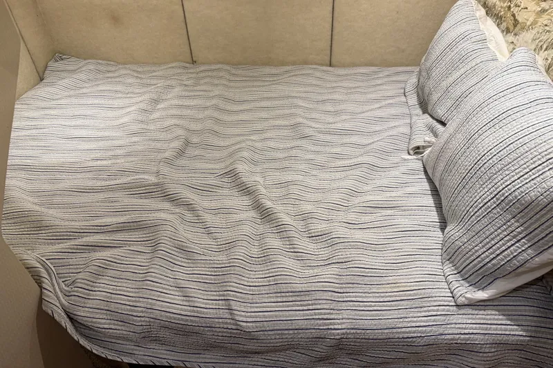 Touchdown Yacht Photos Pics Cozy bed with striped bedding in 2000 Bayliner 3988 Command Bridge Motoryacht cabin.