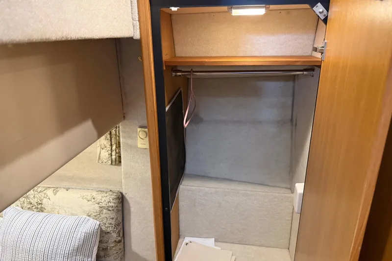 Touchdown Yacht Photos Pics Interior of 2000 Bayliner 3988 Command Bridge Motoryacht showing closet and seating area.