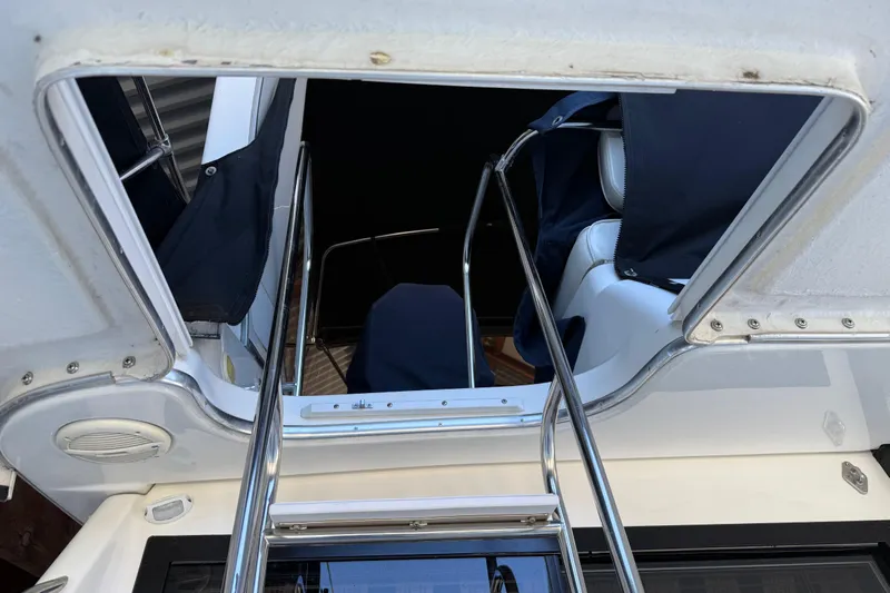 Touchdown Yacht Photos Pics 2000 Bayliner 3988 Command Bridge Motoryacht interior view with ladder and seating.