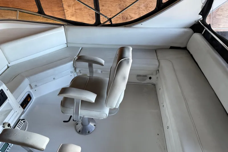 Touchdown Yacht Photos Pics 2000 Bayliner 3988 Command Bridge Motoryacht interior with white seating and helm chair.