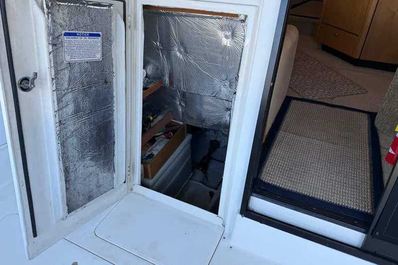 Touchdown Yacht Photos Pics 2000 Bayliner 3988 Command Bridge Motoryacht interior with open hatch and storage area.