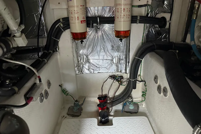 Touchdown Yacht Photos Pics Engine room of 2000 Bayliner 3988 Command Bridge Motoryacht with fuel filters and wiring.