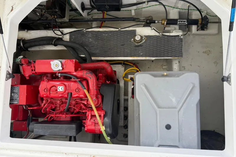 Touchdown Yacht Photos Pics Engine compartment of a 2000 Bayliner 3988 Command Bridge Motoryacht with red engine components.