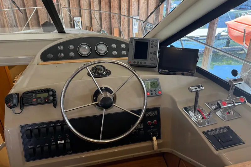 Touchdown Yacht Photos Pics Helm of 2000 Bayliner 3988 Command Bridge Motoryacht with steering wheel and navigation equipment.