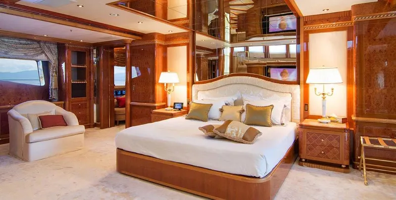  Yacht Photos Pics Luxurious bedroom interior on 2007 Benetti 56M yacht, featuring elegant wood finishes and plush furnishings.