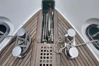 Bow of 2010 Aicon 85 yacht with ropes and cleats on wooden deck.