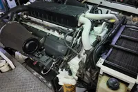 Engine of a 2010 Aicon 85 yacht, showcasing intricate mechanical components and filters.