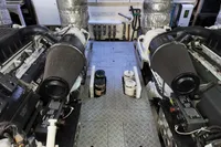 Engine room of a 2010 Aicon 85 yacht, featuring dual engines and mechanical components.