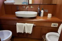 Luxurious bathroom in 2010 Aicon 85 yacht with modern fixtures and wooden cabinetry.