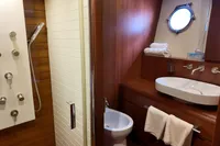 Luxurious bathroom on 2010 Aicon 85 yacht with modern shower and porthole window.